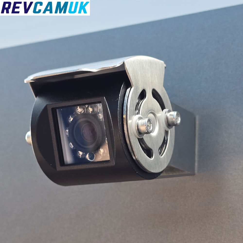 Black rear-view or parking camera with adjustable lens angle, shown mounted on a polished stainless-steel bracket for secure installation