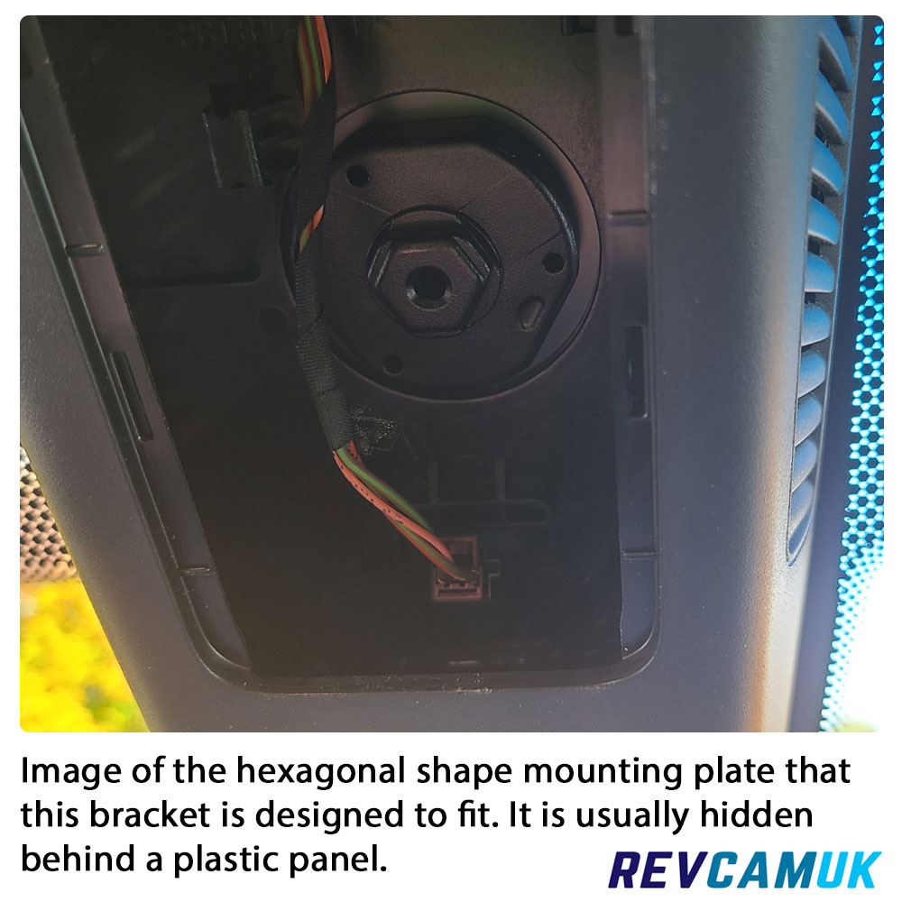 Hexagonal Mercedes Sprinter mirror monitor mounting plate shown behind the plastic trim, displaying the OEM fitting used for compatible mirror-mount brackets.